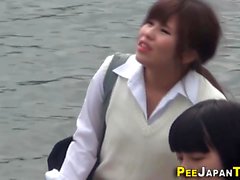 Asian teens pee in park