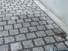 Asian urinates in street