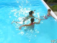 Bikini babes fool around in a pool