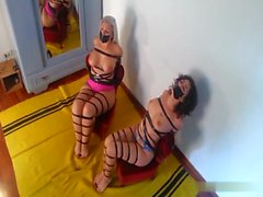 Two girls taped to chairs and toetied