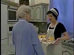 French maid fists a mature slut in the kitchen