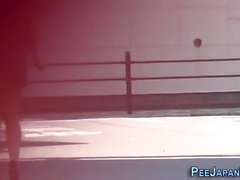 High heeled asian ho pees on road